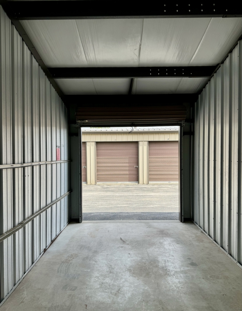 View from the inside back of a secure storage locker looking out through the open door at the entrance.